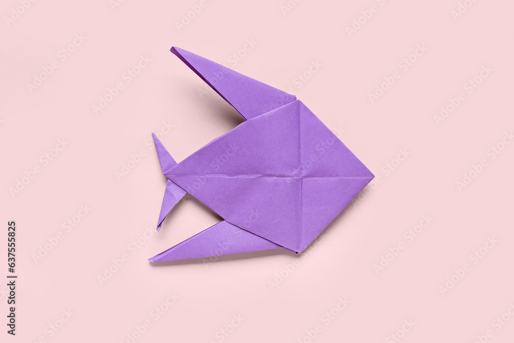 Purple origami fish on pink background