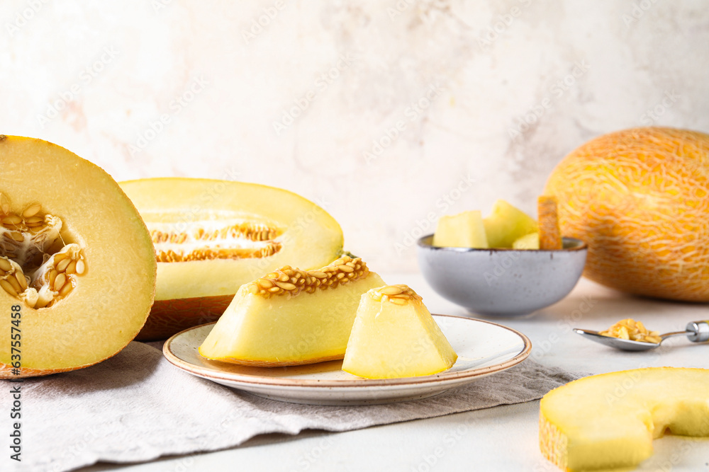 Plate and bowl with pieces of sweet melon on white background