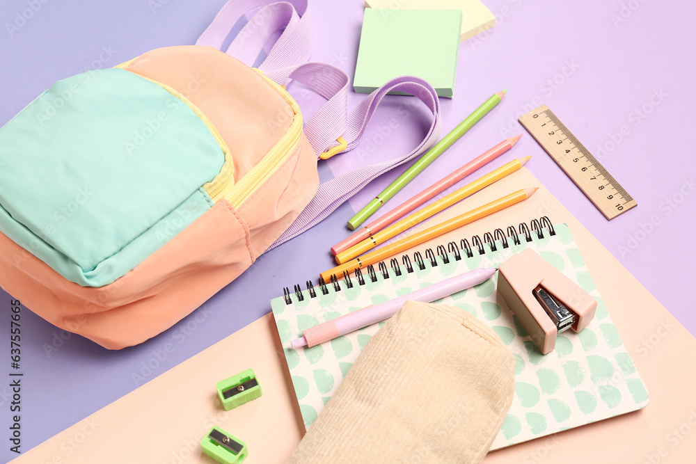 Stylish school backpack with different stationery supplies on colorful background