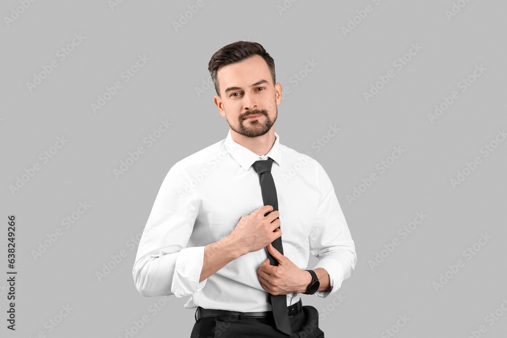 Handsome businessman on grey background