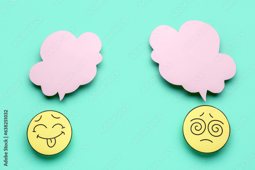 Paper faces with blank speech bubbles on turquoise background