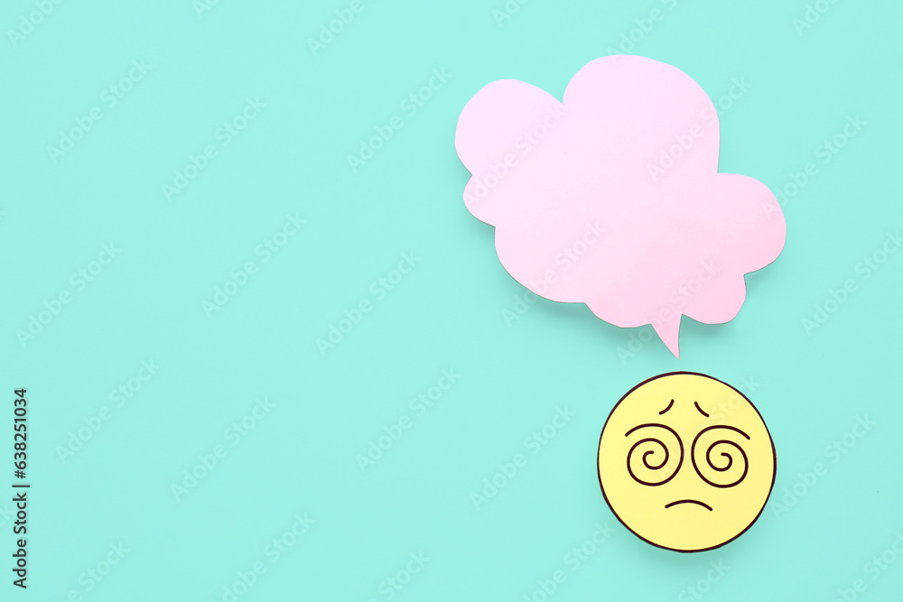 Confused paper face with blank speech bubble on turquoise background