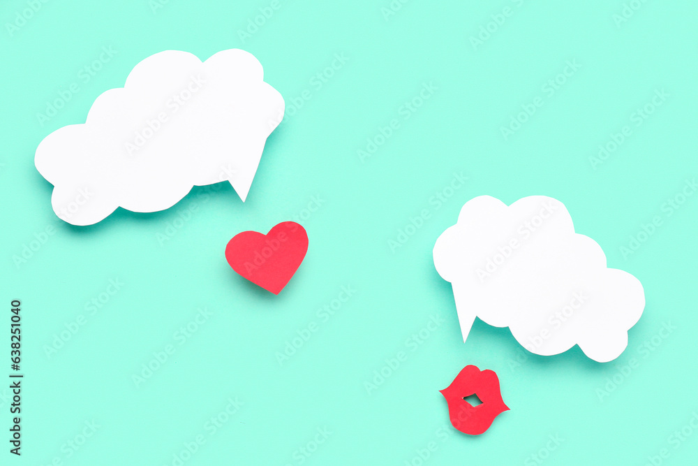 Paper lips and heart with blank speech bubbles on turquoise background