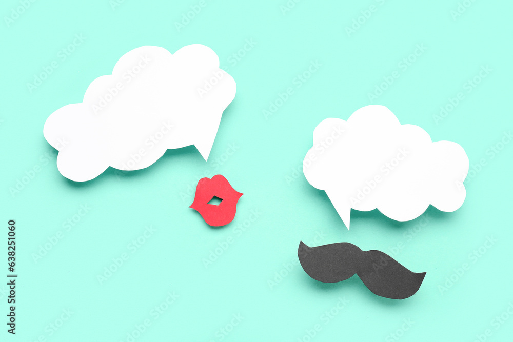 Paper lips and mustache with blank speech bubbles on turquoise background