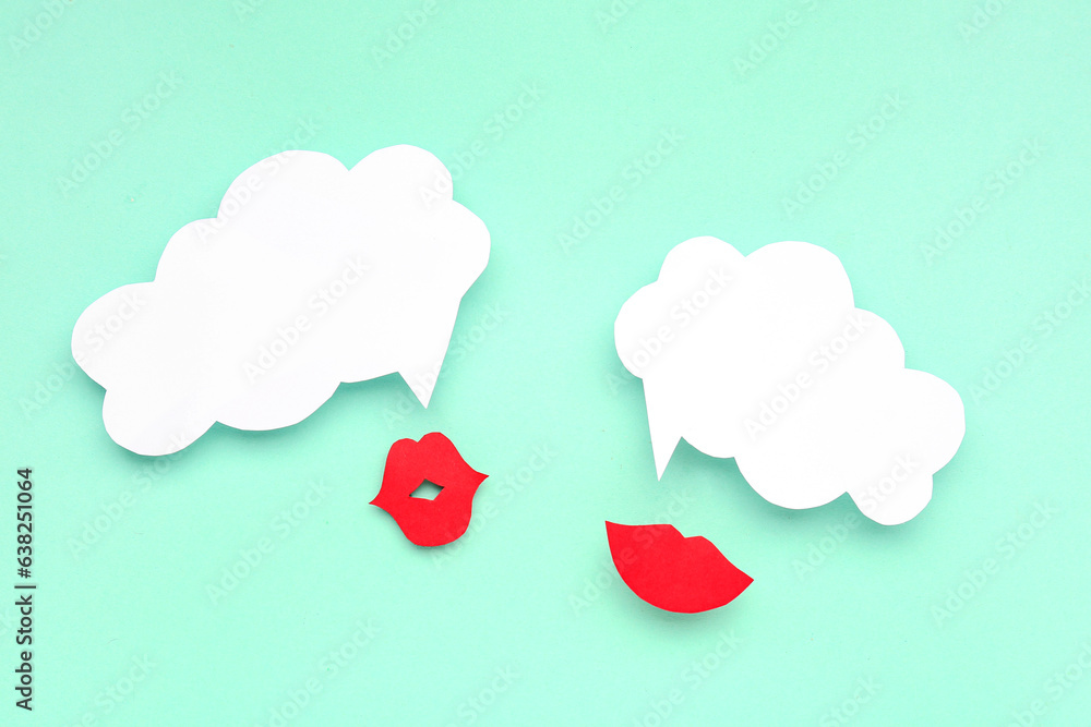 Paper lips with blank speech bubbles on turquoise background