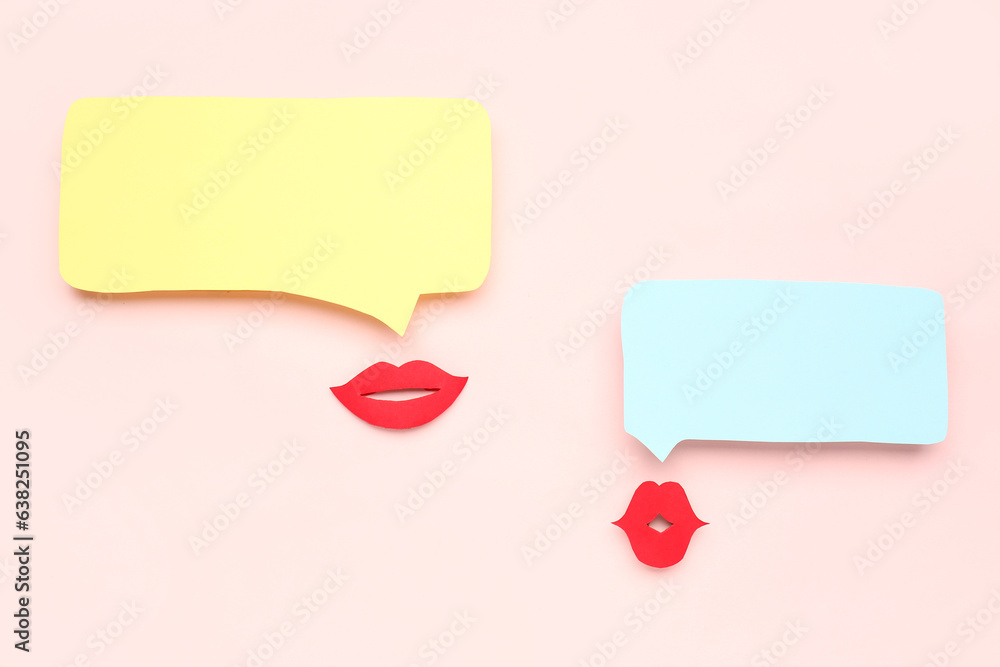 Paper lips with blank speech bubbles on pink background