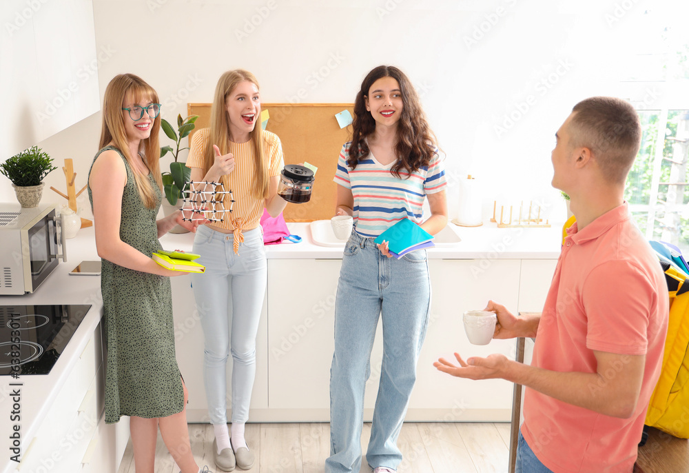 Group of students drinking coffee in kitchen