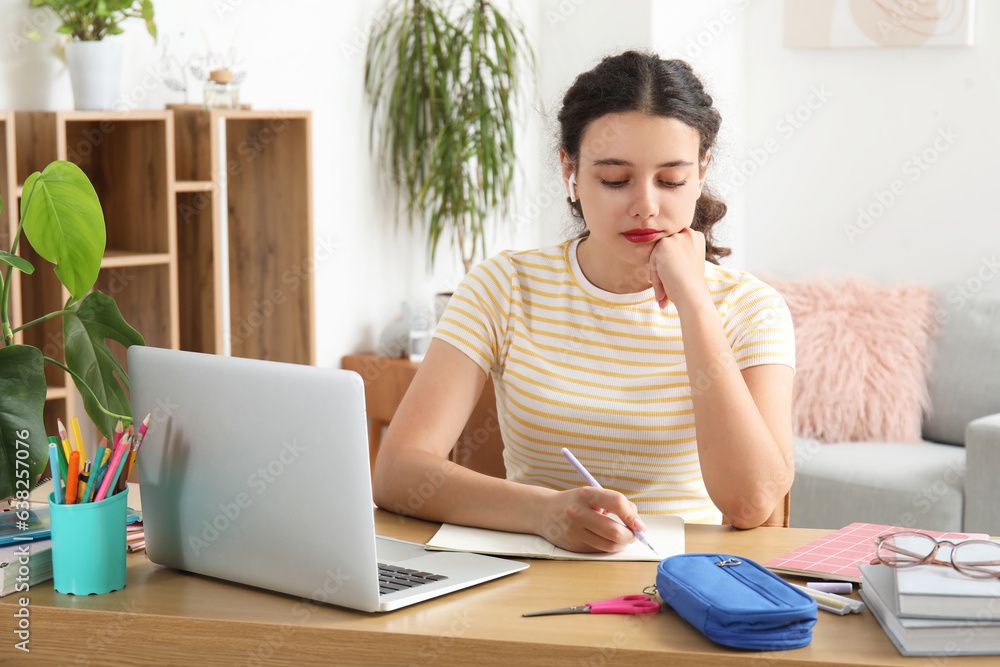 Female student doing lessons at home