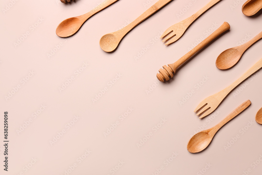 Wooden kitchen utensils on beige background