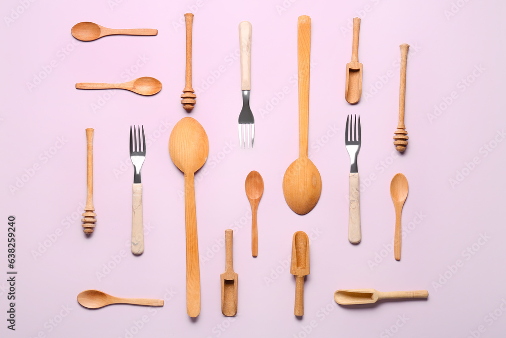 Wooden kitchen utensils on lilac background