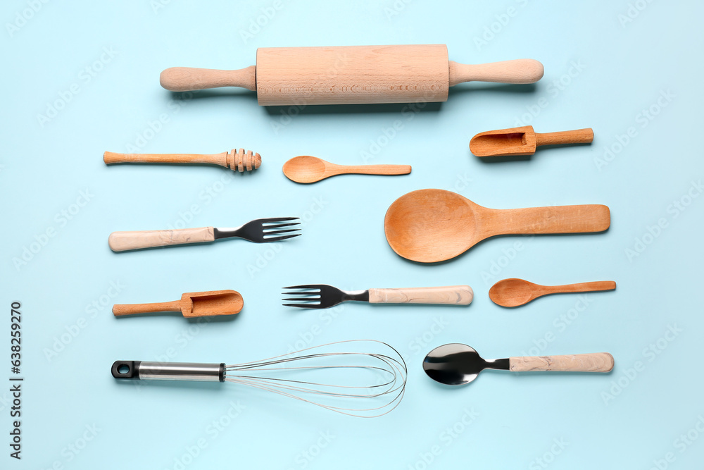 Set of wooden kitchen utensils on blue background