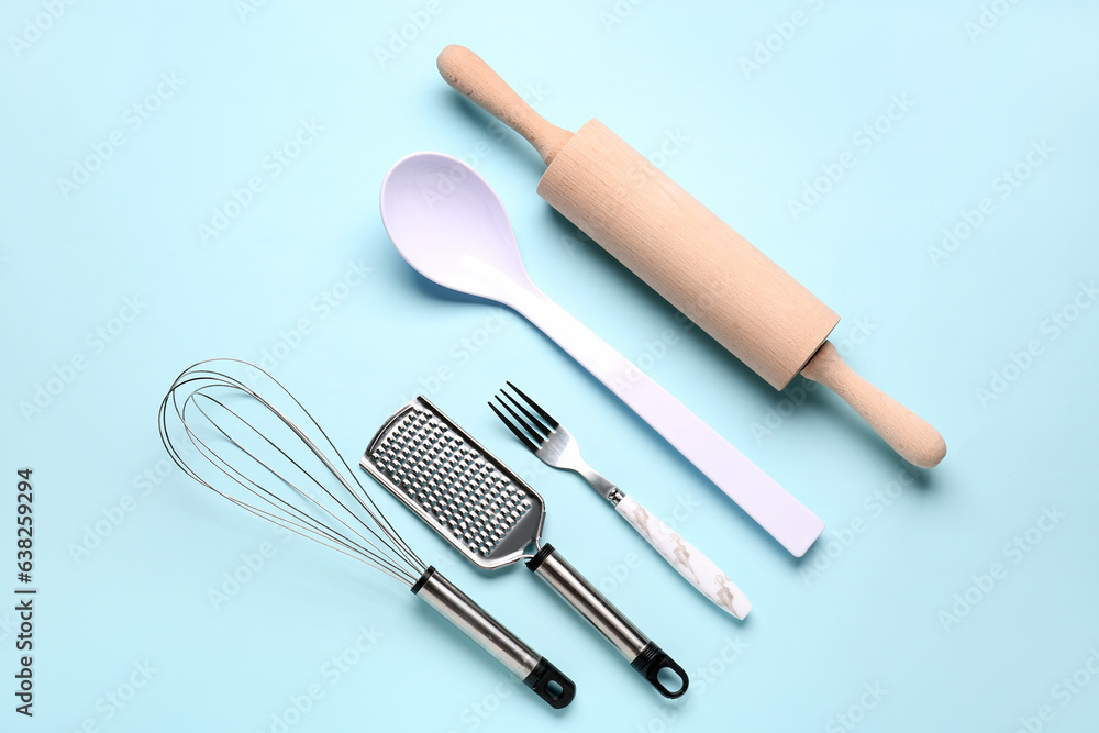 Set of kitchen utensils on light blue background