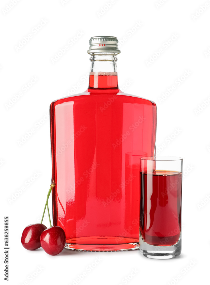 Glass and bottle of sweet cherry liqueur with berries on white background