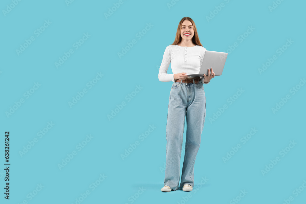 Female programmer with laptop on blue background