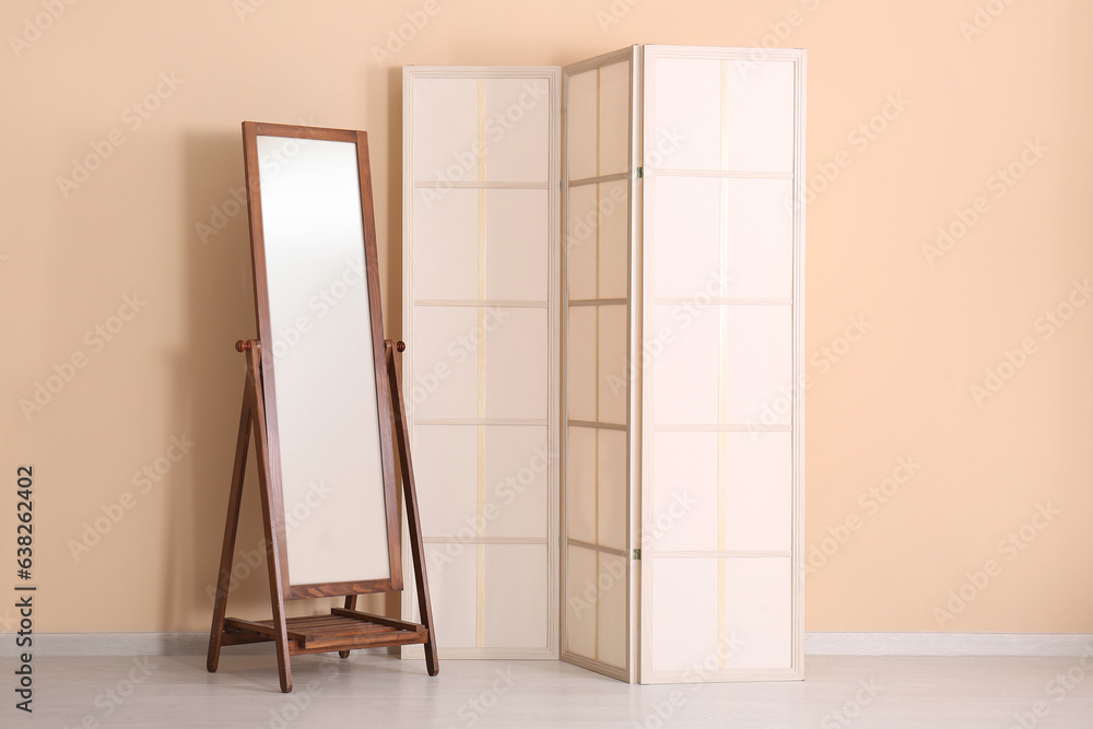 Folding screen and mirror near beige wall