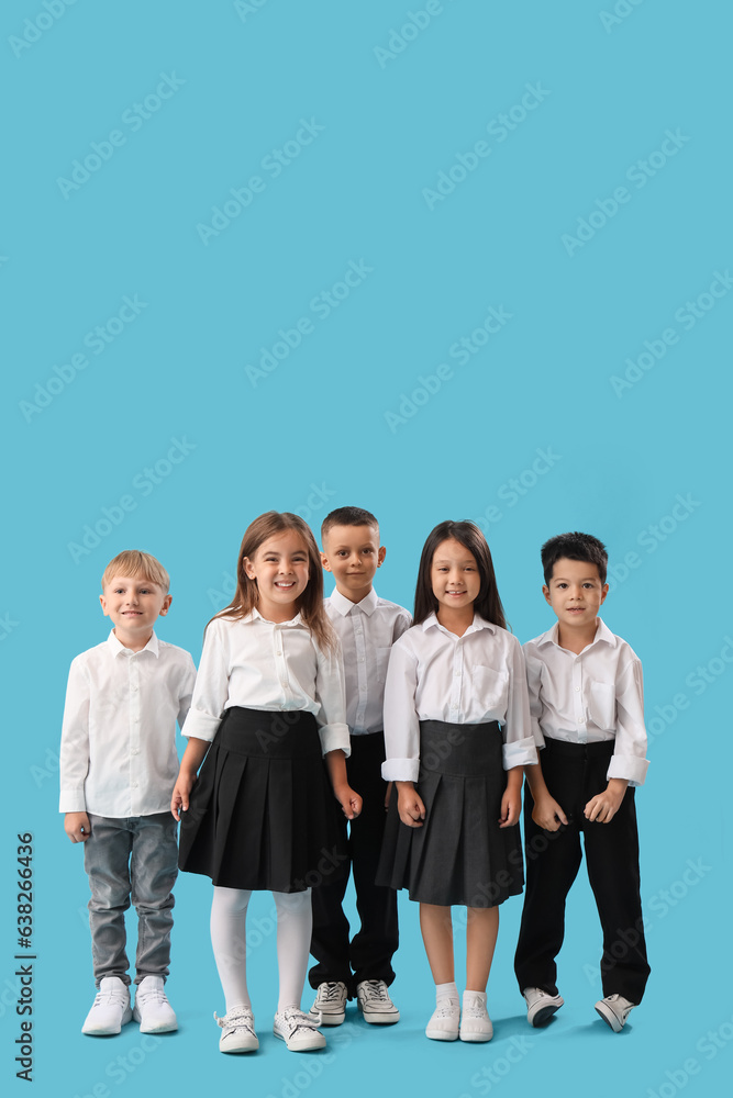 Little school children on light blue background