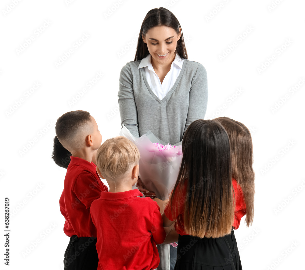 Little school children with female teacher and bouquet of flowers on white background