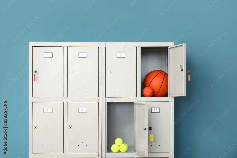 Modern locker with sports equipment near blue wall