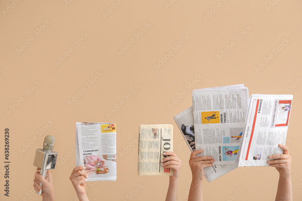 Female hands with different newspapers and microphone on color background