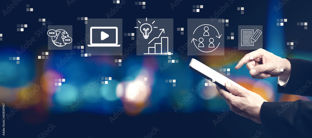 Content marketing concept with businessman using a tablet computer at night