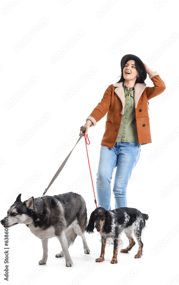 Young woman with cute dogs walking on white background