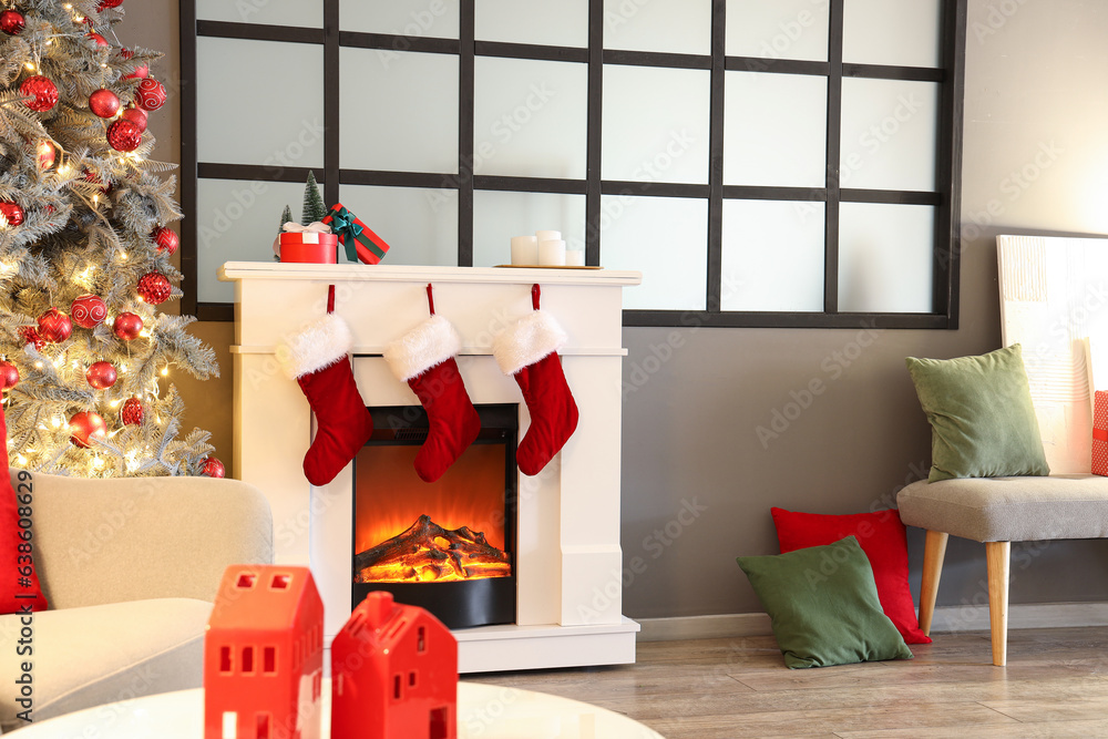 Interior of cozy living room with fireplace decorated for Christmas