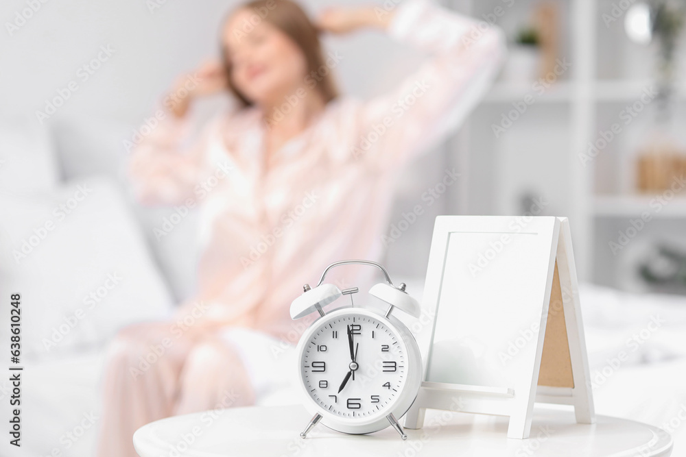 Alarm clock on table in bedroom