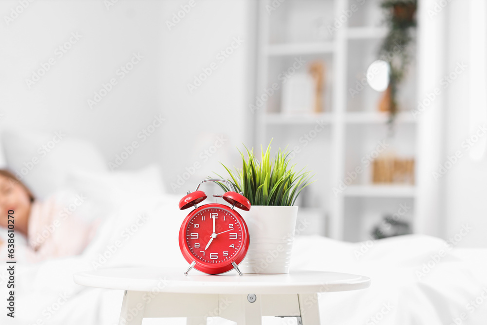 Alarm clock on table in bedroom