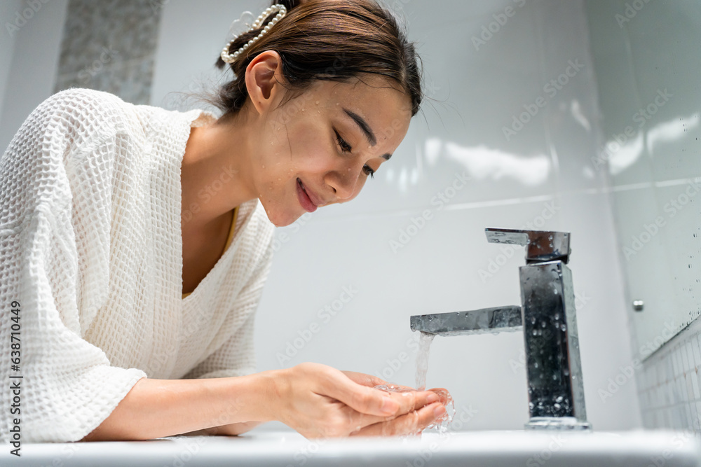 Asian beautiful woman washing her clean face with facial foam and water. 