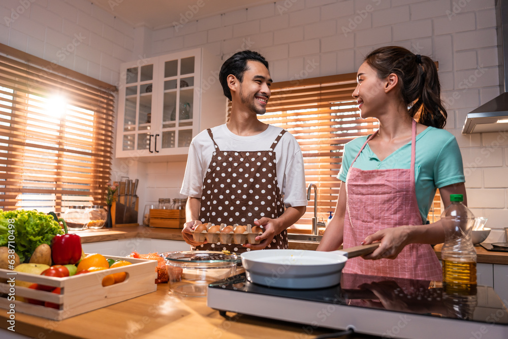 Asian young new marriage couple spend time together in kitchen at home. 