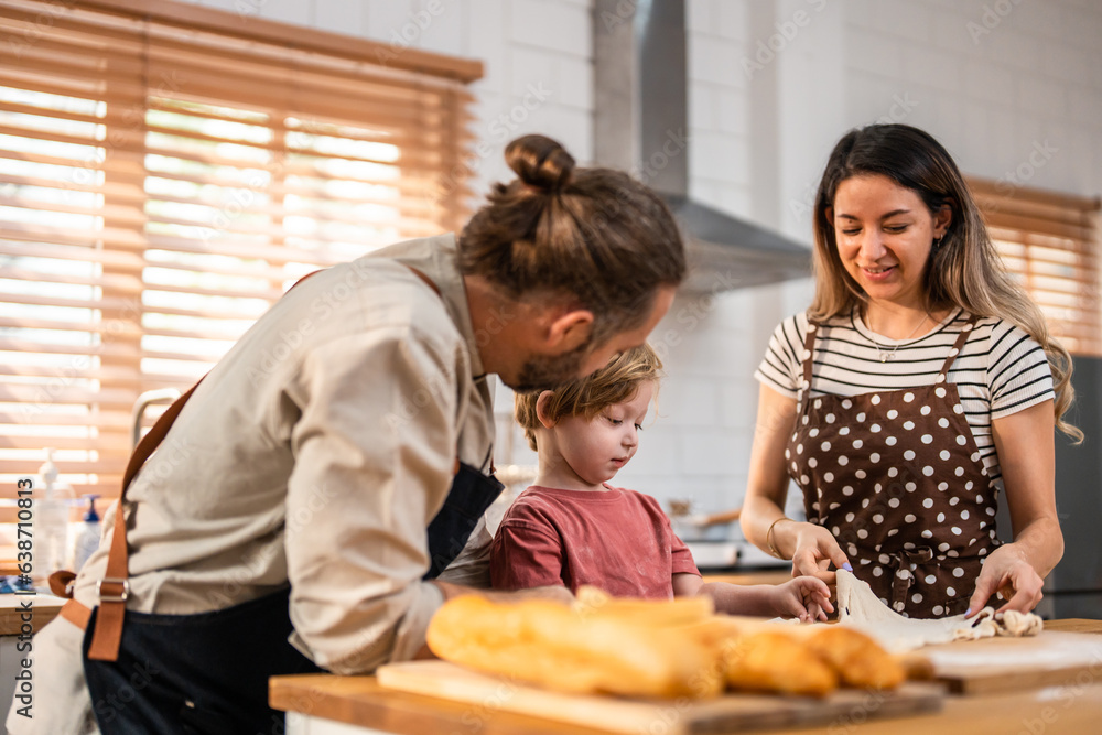 Caucasian attractive couple baking bakery with son in kitchen at home. 