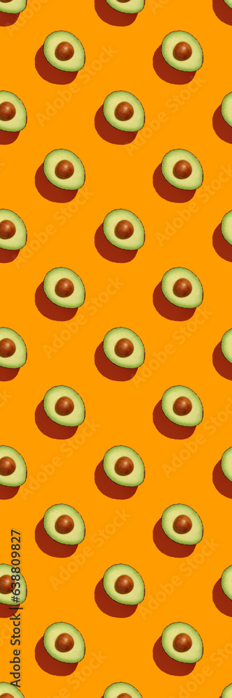 Avocado on orange background pattern top view flat lay