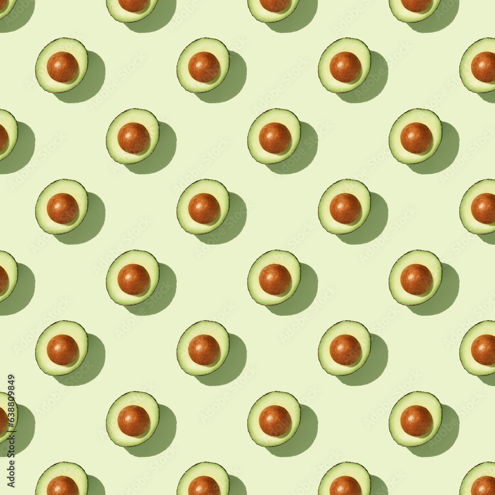 Avocado on green background pattern top view flat lay