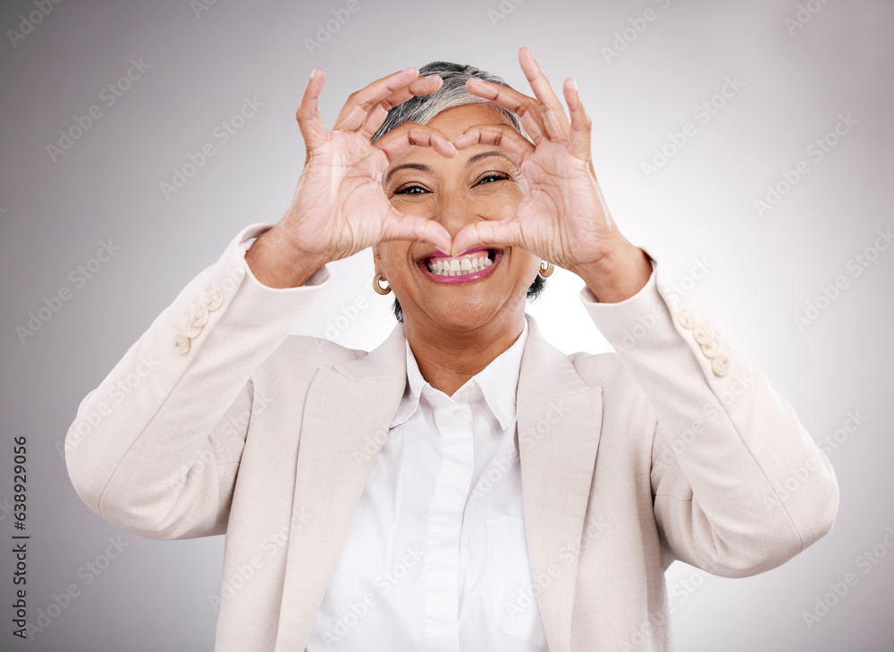 Smile, portrait and a woman with heart hands on a studio background for business or corporate career