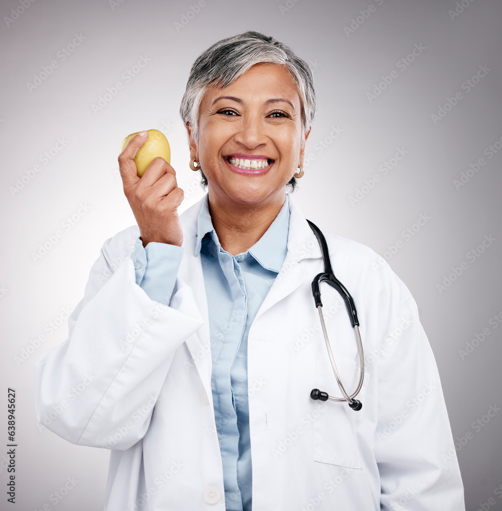 Doctor, woman and portrait with apple in studio for vitamin c benefits, detox and dietician on gray 