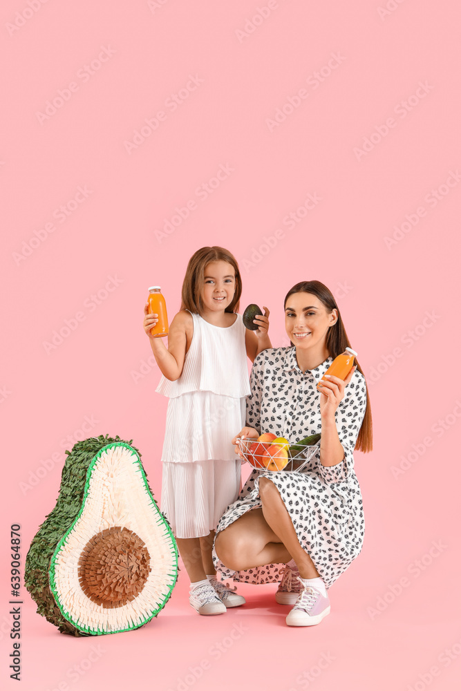 Little girl with her mother and juice on color background