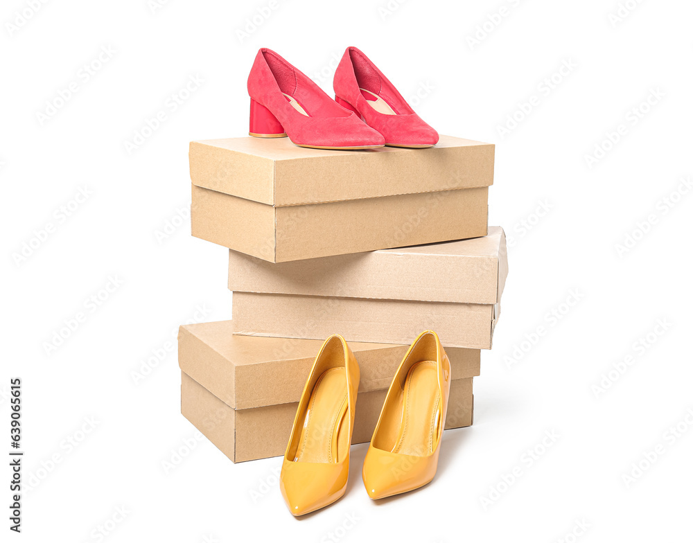 Cardboard boxes with stylish female shoes on white background