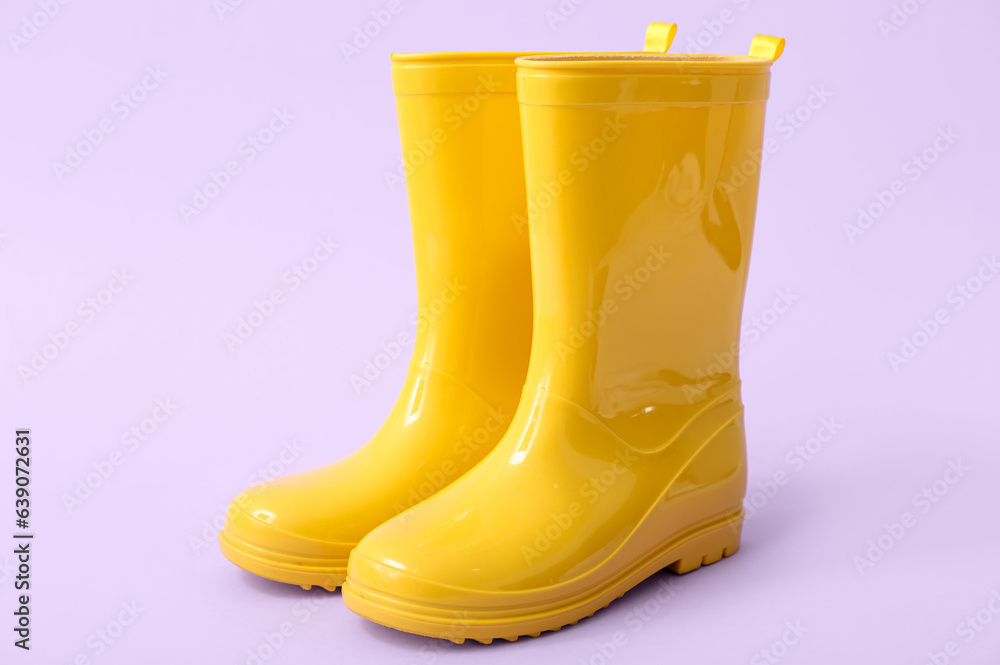 Yellow gumboots on lilac background