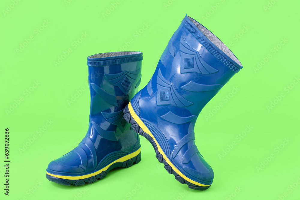 Blue gumboots on green background