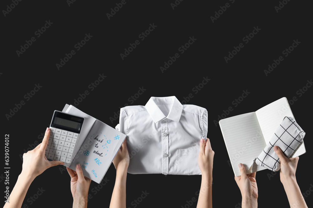 Female hands holding stationery, school uniform and notebooks with text BACK TO SCHOOL on black back