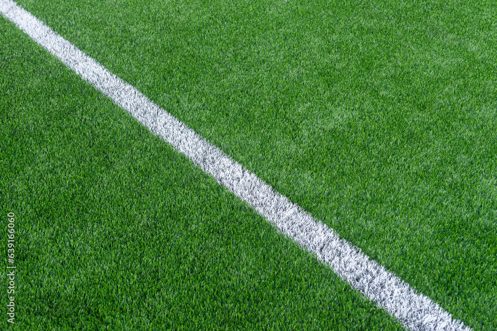 Green synthetic grass sports field with white line shot from above. Soccer, hurling, lacrosse, rugby