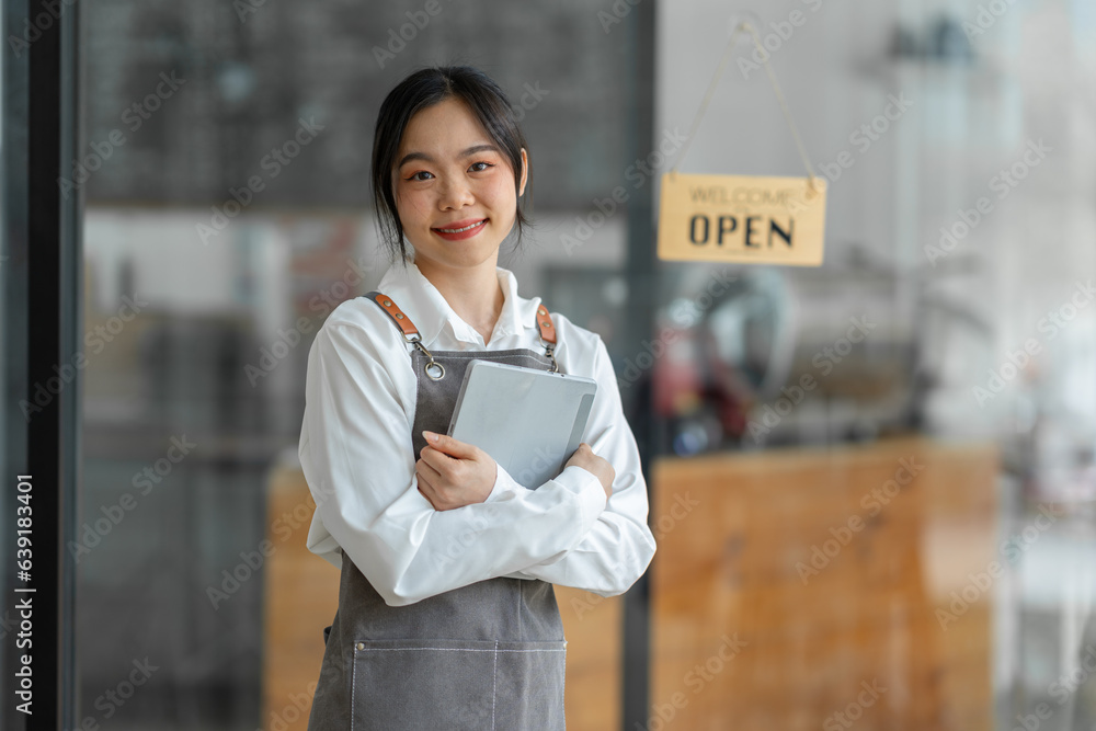 Young successful small business owner standing with tablet in cafe Portrait of an Asian female baris