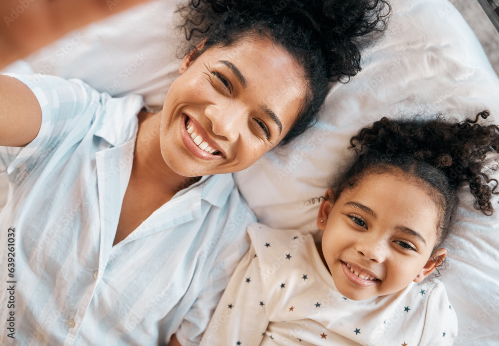 Top view, selfie and mother with girl child on a bed happy, bond and relax at home. Love, profile pi