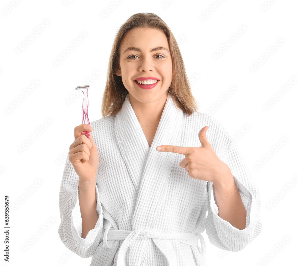 Young woman pointing at razor on white background