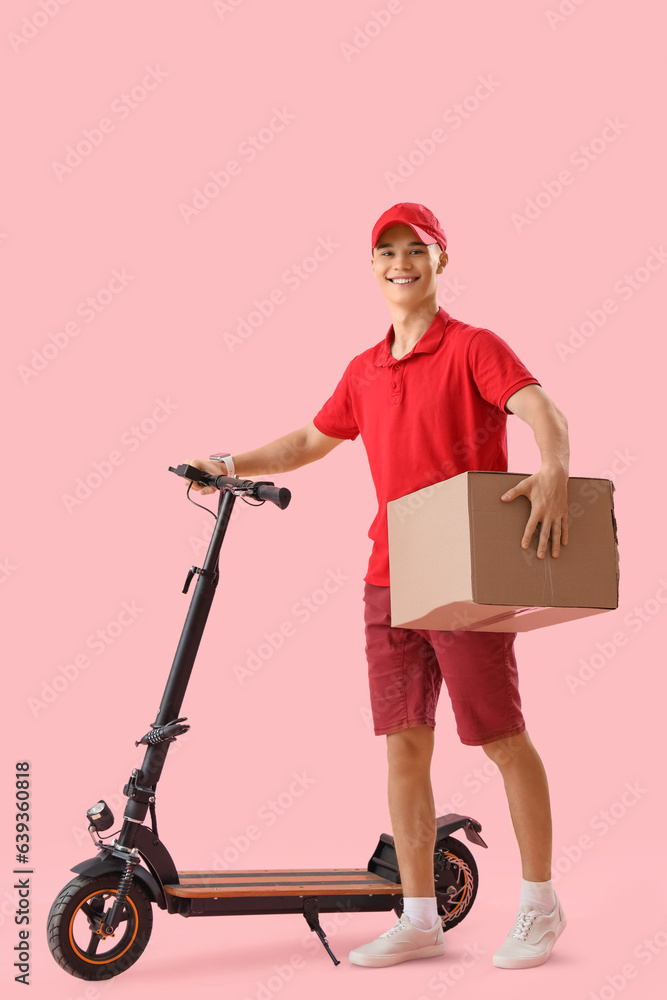 Young courier with parcel and scooter on pink background