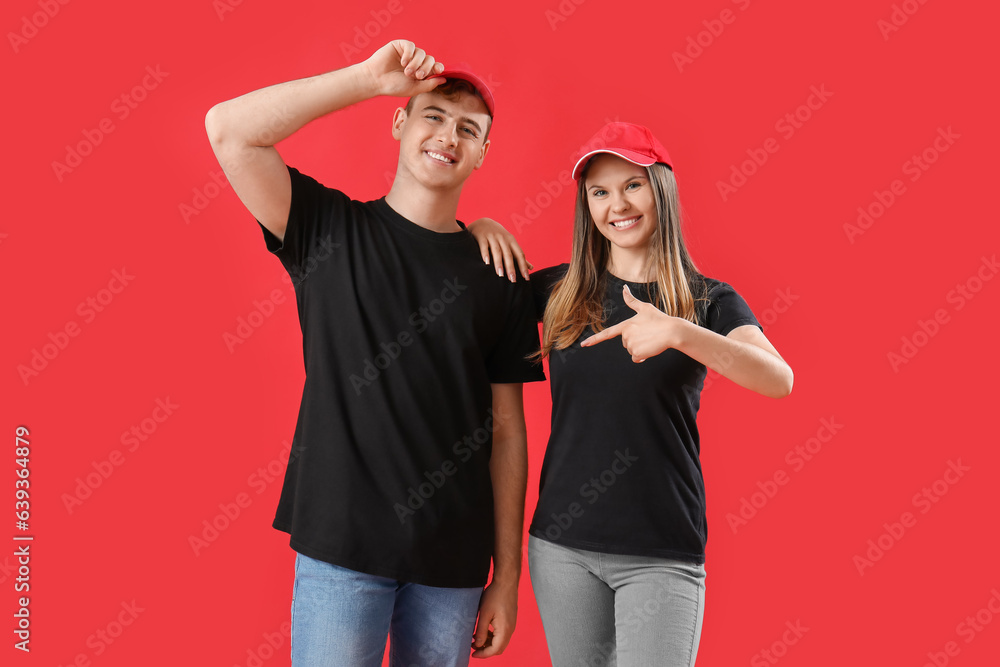 Young couple in black t-shirts on red background