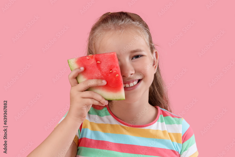 Happy little girl with slice of fresh watermelon on pink background