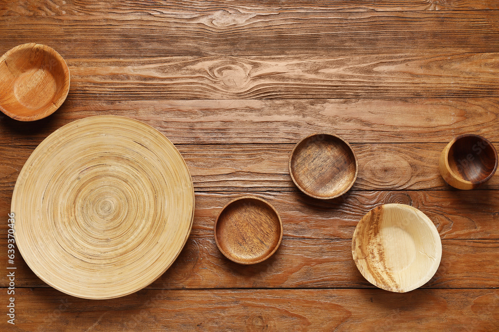 Plates and bowls on wooden background