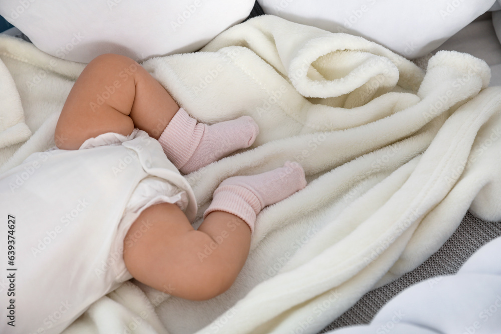 Cute baby lying in crib, closeup