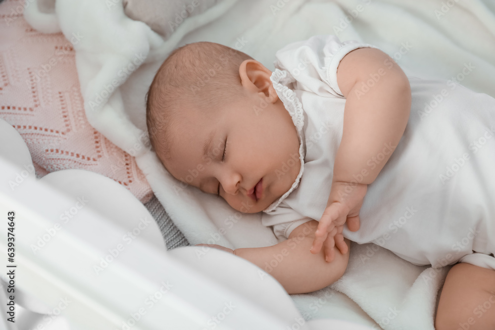 Cute baby lying in crib, closeup